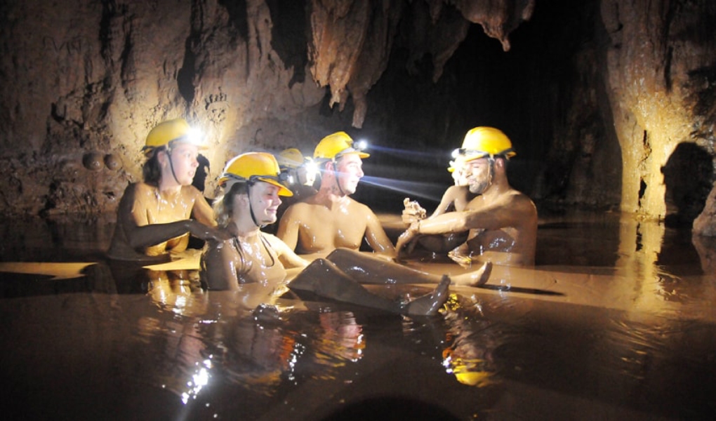 taking a mud bath in dark 1 - Phong Nha Cave Tours: Explore Central Vietnam's UNESCO Wonders