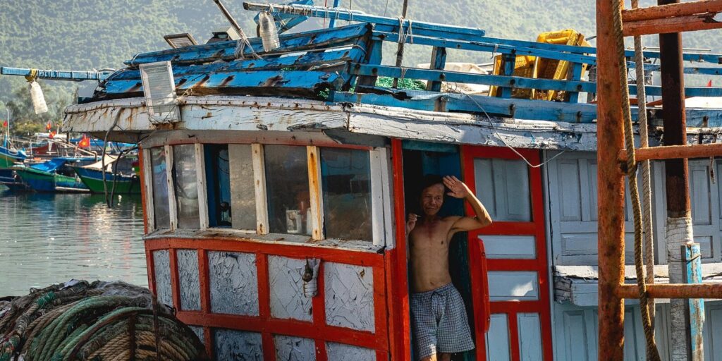 A fisherman in his boat. Photo from Vietnam in focus - Weather in Central Vietnam: Your Helpful Travel Guide