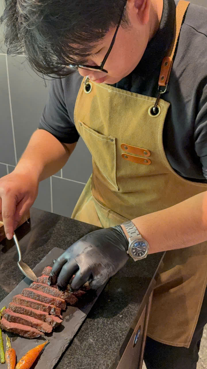 Chef Huy preparing and plating a sliced steak at El Toro restaurant in Thao Dien